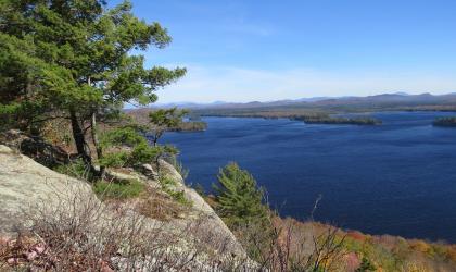 The view of a large lake from a rocky ledge