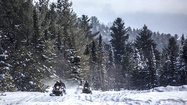 Snowmobiling on a corridor trail in the Adirondacks.