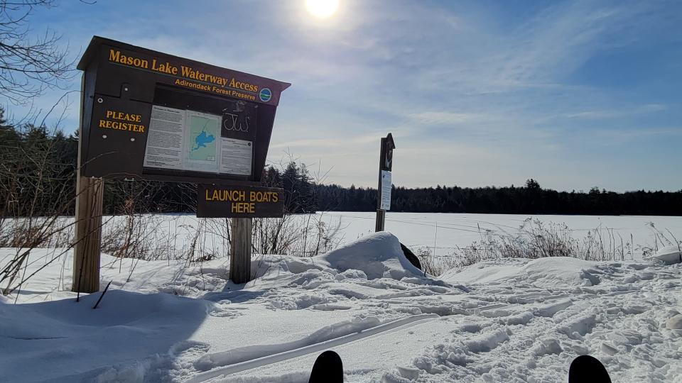 Sign for Mason Lake in front of the frozen lake