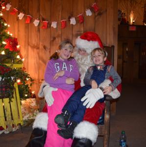 Kids sitting with Santa.