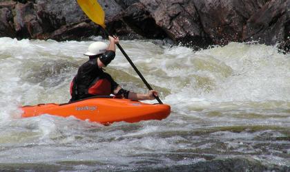 A whitewater kayaker navigating rapids