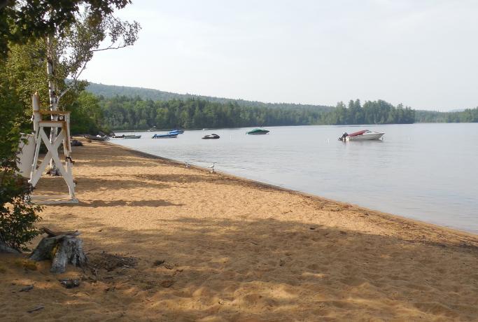 A sandy lake beach is part of the amenities.