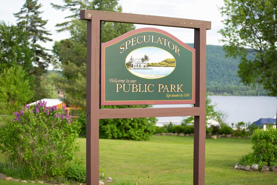 Speculator Public Park sign surrounded by greenery