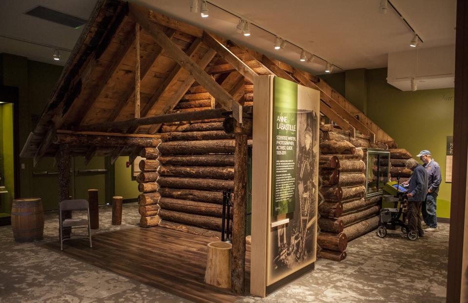 A cabin on display inside a museum.