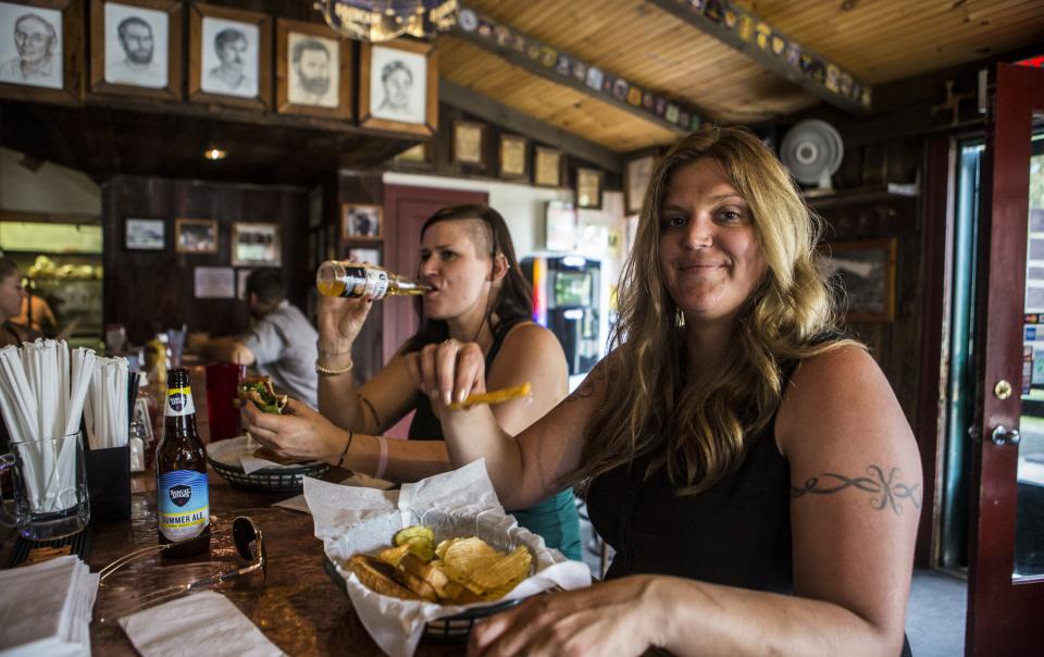 two women eat at a bar in Raquette Lake.
