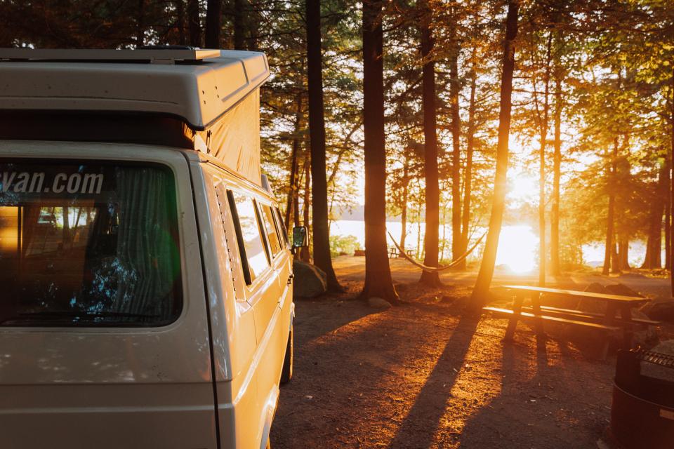 A camper van at sunset during fall