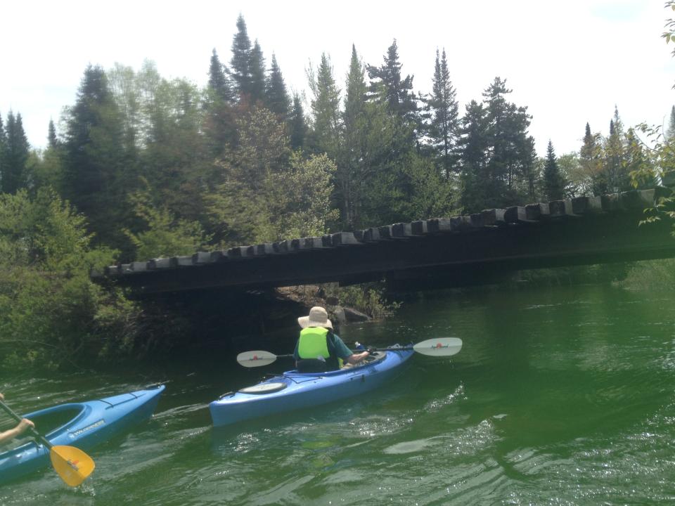 Kayakers struggle against the current.