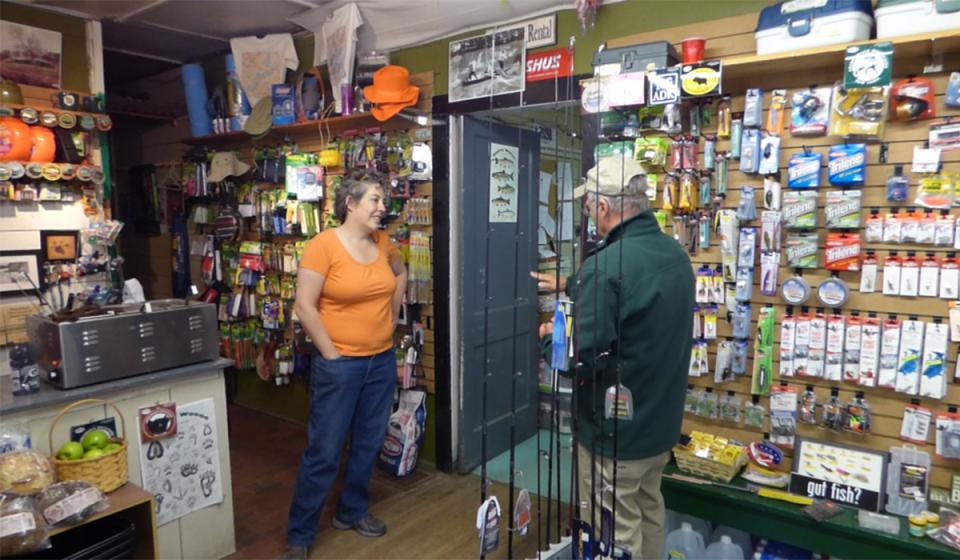 Store owner, Vickie speaks with a local angler about the fishing tackle selection