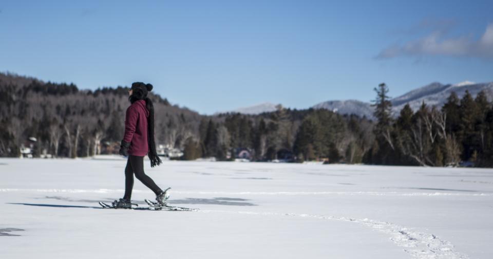 Woman snowshoeing on lake