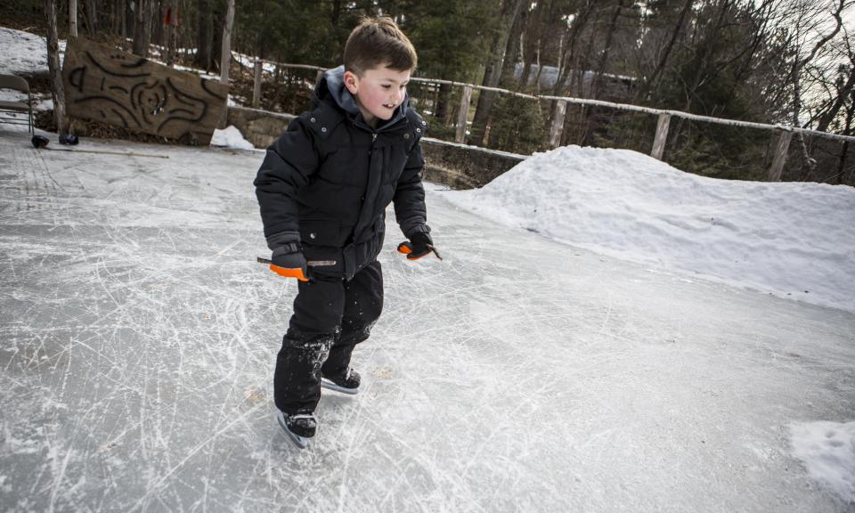 Boy skating on Adirondack pond