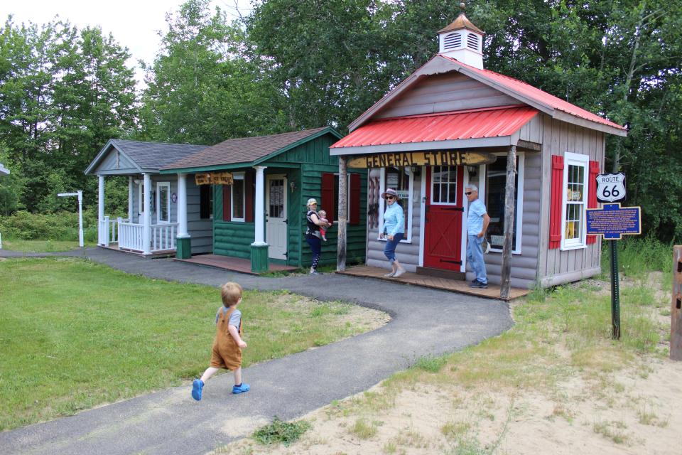 A family exploring Speculator's miniature Route 66!