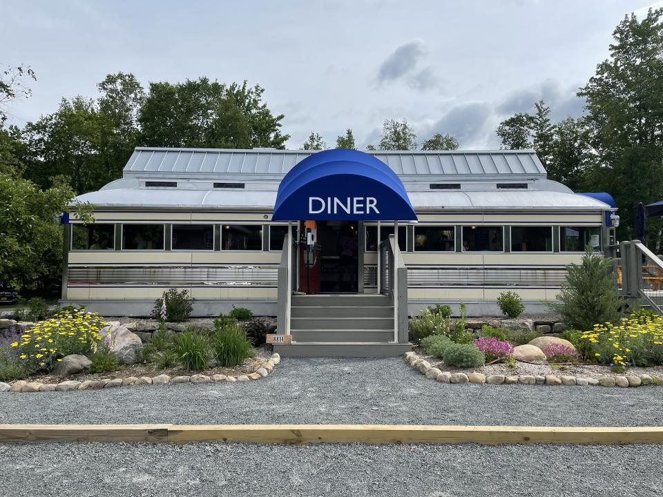 Chef Darrell's Mountain Diner, a metallic grey and blue building with a freshly landscaped front.