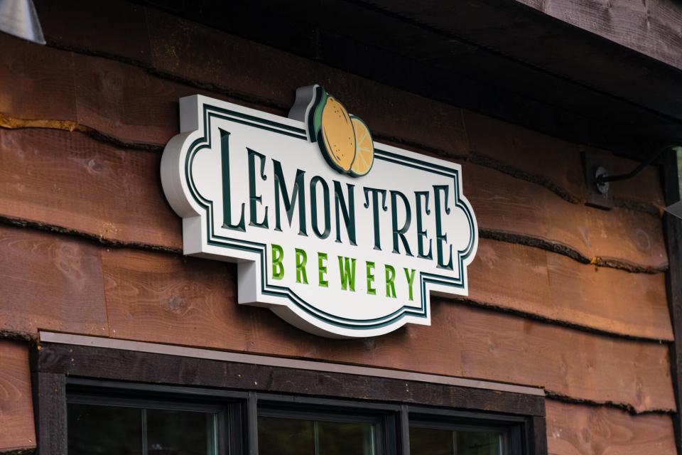 A wooden entrance sign welcomes you to Lemon Tree Brewery