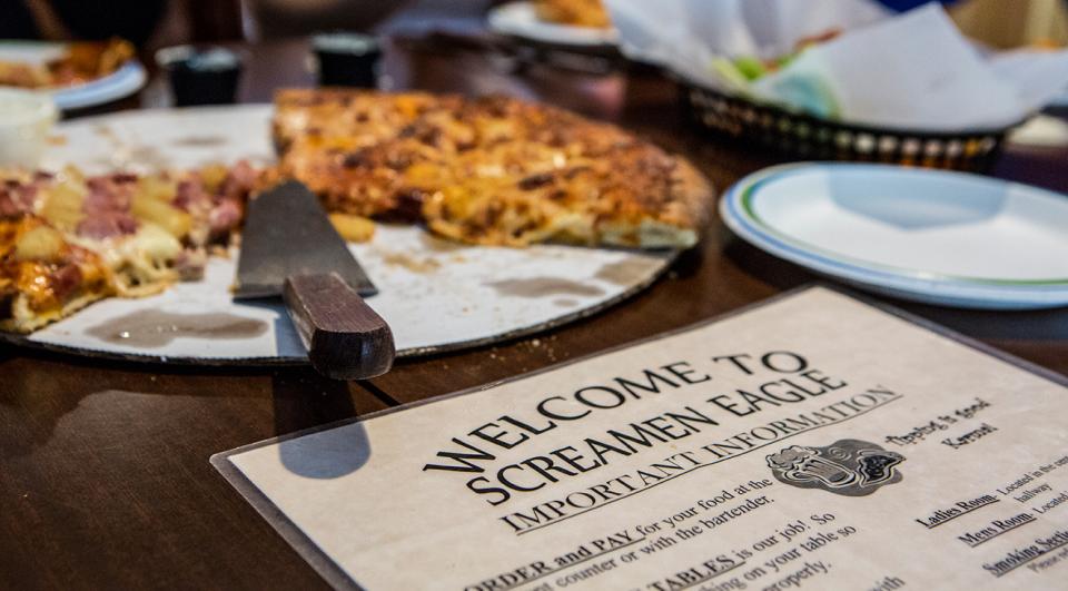 A pizza and a menu at a place to eat