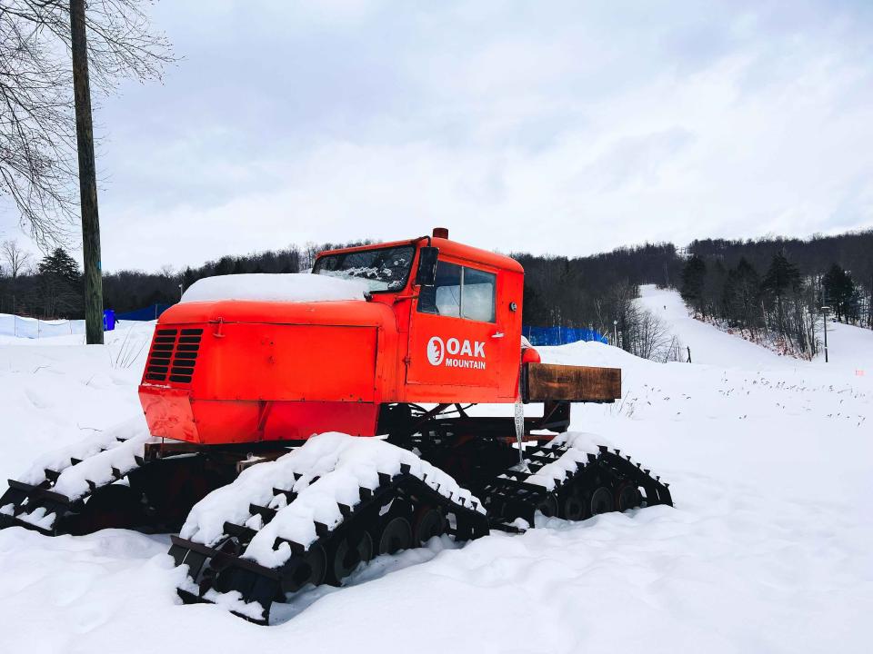 An orange piece of equipment used at the ski mountain.