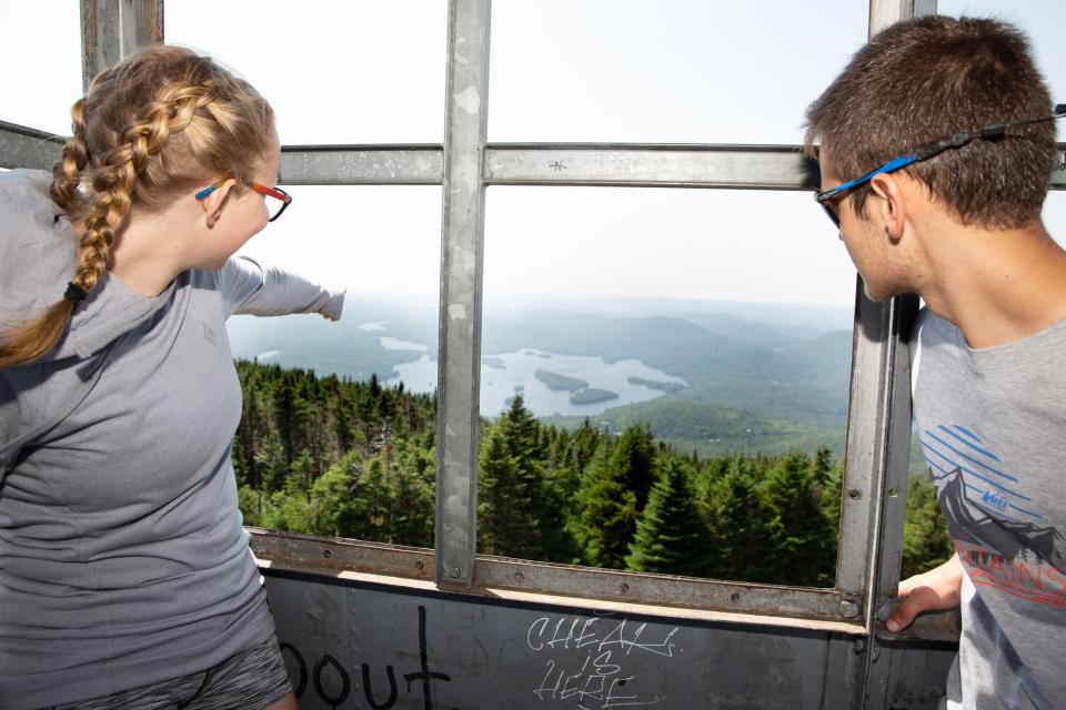Two people enjoying view from firetower