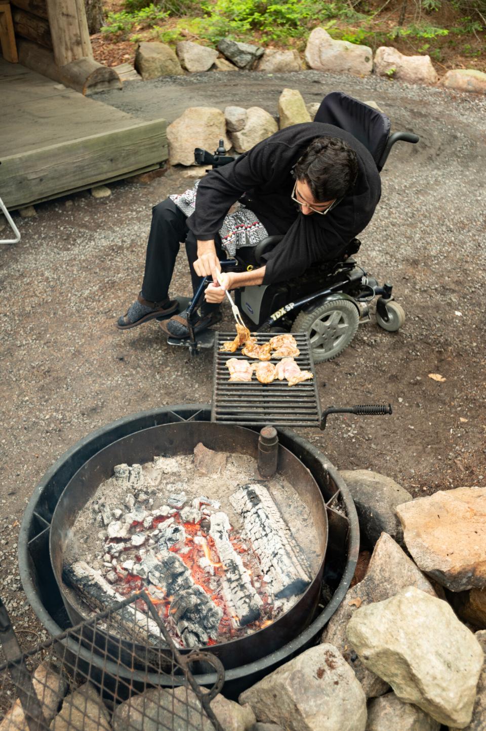The author grilling over a specialized, accessible outdoor camping grill.