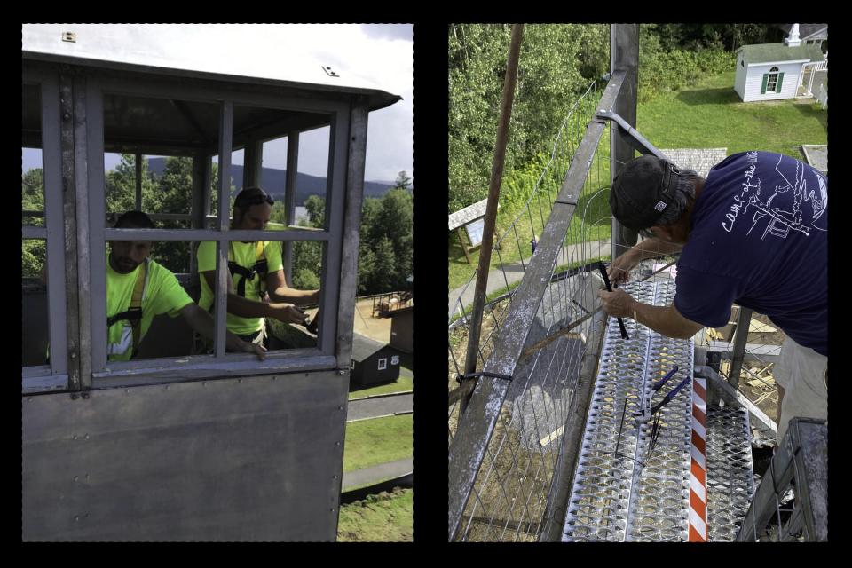 Men working in the fire tower cab and on the stairs.