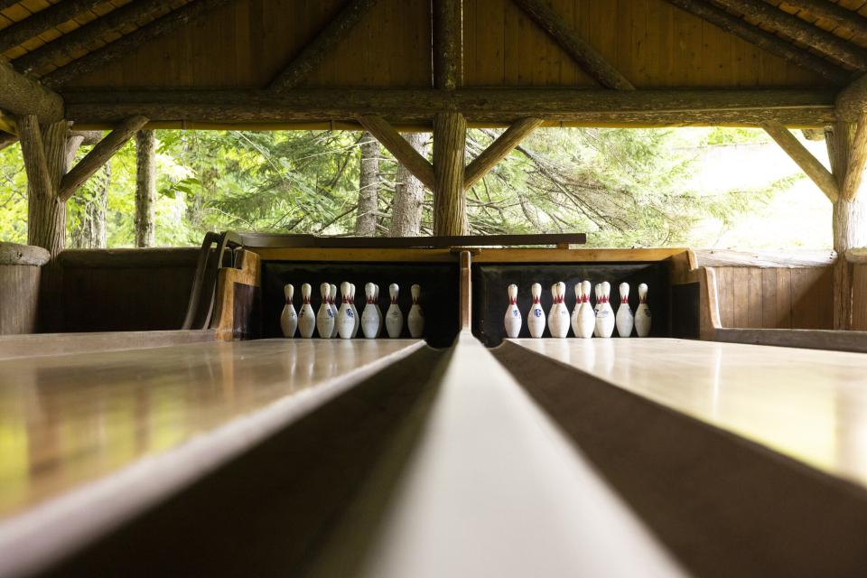 A close-up of the two lanes of an antique, historic outdoor bowling alley.