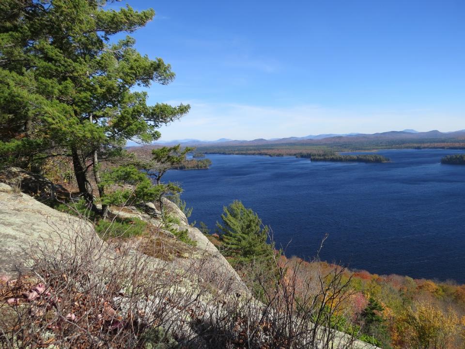 A cliff on a summit overlooking a large lake