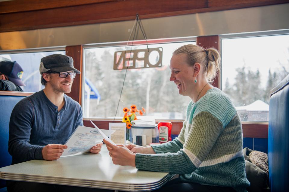 A couple sits at a diner booth at Chef Darrell's Mountain Diner in Blue Mountain Lake