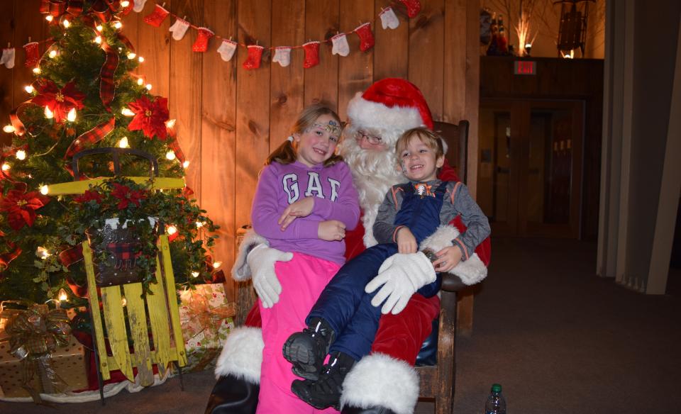 Kids sitting with Santa.