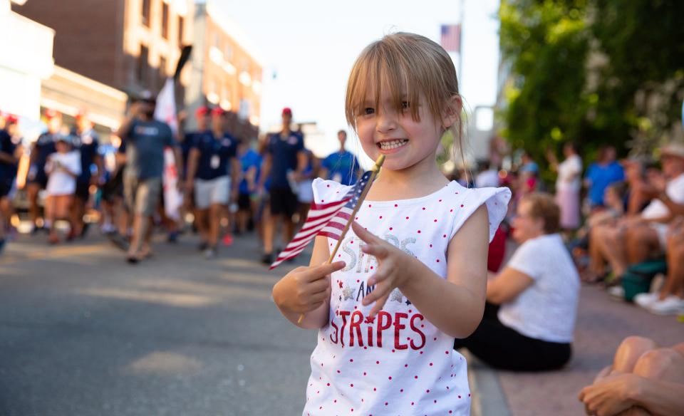 fouth of July parade with liitle girl holding American flag