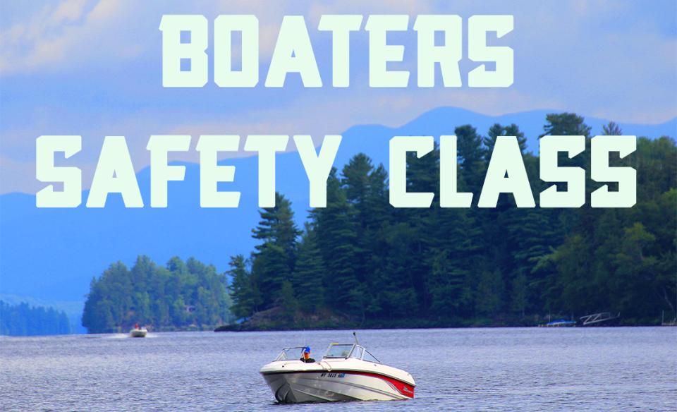 A motorboat on a lake with pine trees and mountains in the backgroung with the title- boaters safety class overhead