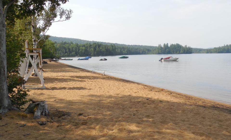 A sandy lake beach is part of the amenities.
