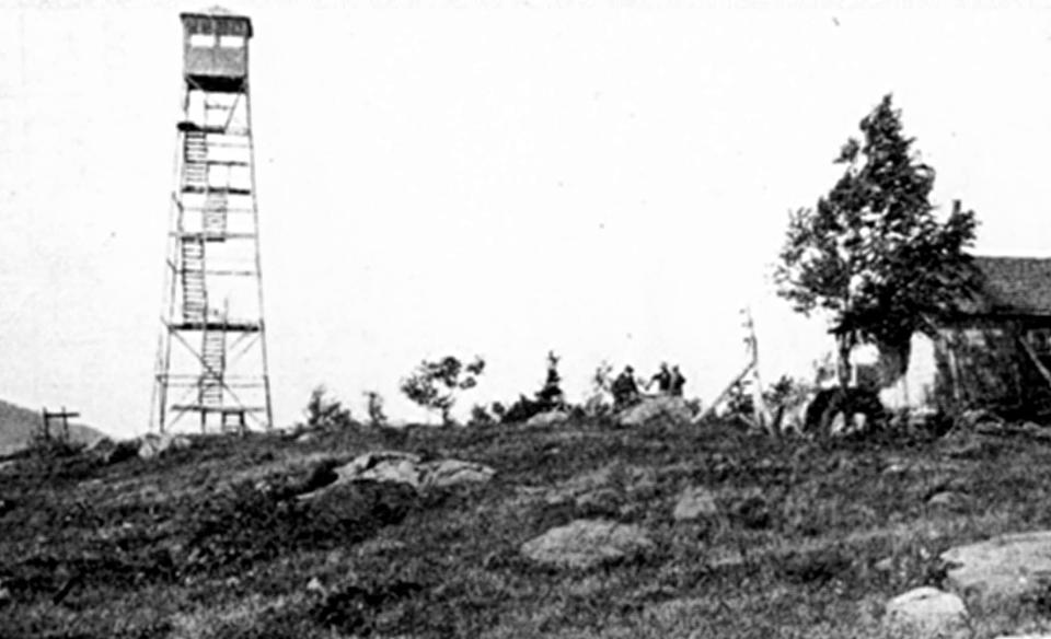 A historic photo of the Makomis fire tower sitting atop Makomis Mountain