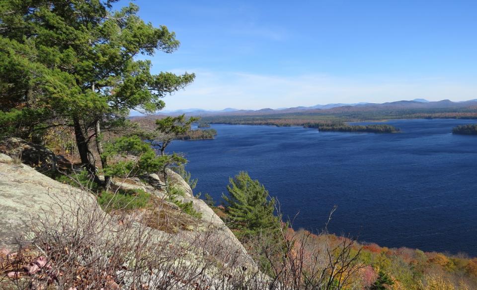 A summer view of Lake Lila from a rocky outcrop with pines.